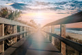 Golden Horizon: Coastal Boardwalk at Sunrise Canvas Print